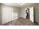 Carpeted bedroom with a closet and view of the kitchen, bathed in sunlight at 120 Gran De, Atlanta, GA 30349