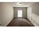 Bedroom with carpeted floor, window, double closet, and painted in neutral shade at 120 Gran De, Atlanta, GA 30349