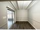 Dining room features wood floors, gray walls, wainscotting, and access to the screened porch at 120 Gran De, Atlanta, GA 30349