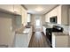 Bright kitchen features white cabinets, stainless appliances, granite countertops and wood look floors at 120 Gran De, Atlanta, GA 30349