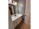 Bathroom features a white vanity with black fixtures and a mirror with sconce lighting at 2533 Whispering Pines Dr, Grayson, GA 30017