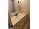 Bathroom vanity featuring a mirror and wall lighting above a sink, as well as storage space at 2533 Whispering Pines Dr, Grayson, GA 30017
