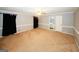 Large bedroom with neutral walls, carpet flooring, ceiling fan and adjacent bathroom entrance at 2533 Whispering Pines Dr, Grayson, GA 30017