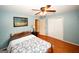 Comfortable bedroom with wooden floors, ceiling fan, and double closet doors at 2533 Whispering Pines Dr, Grayson, GA 30017