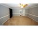 Bedroom featuring gray walls, white trim, ceiling fan, carpet, and connecting door at 2533 Whispering Pines Dr, Grayson, GA 30017