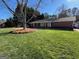 Traditional brick home with well-manicured lawn and mature shade trees at 2533 Whispering Pines Dr, Grayson, GA 30017