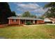 Charming one-story brick home with a well-manicured lawn and inviting covered front porch at 2533 Whispering Pines Dr, Grayson, GA 30017