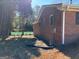 Side view of a brick home displaying well-maintained landscaping and a neat lawn, adding to its curb appeal at 2533 Whispering Pines Dr, Grayson, GA 30017