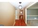Hallway with hardwood floors, modern lighting, and access to multiple rooms for easy navigation at 2533 Whispering Pines Dr, Grayson, GA 30017