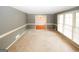 Cozy living room with natural light streaming through large windows and carpeted flooring at 2533 Whispering Pines Dr, Grayson, GA 30017