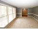Inviting living room with light-filled windows and a seamless transition to adjacent spaces at 2533 Whispering Pines Dr, Grayson, GA 30017