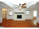 Living room featuring a fireplace, hardwood floors, and natural light, creating a warm and inviting space at 2533 Whispering Pines Dr, Grayson, GA 30017