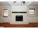 Inviting living room featuring a white brick fireplace, hardwood floors, and direct access to the backyard at 2533 Whispering Pines Dr, Grayson, GA 30017
