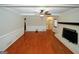 Spacious living room with hardwood floors, ceiling fan, and a charming fireplace, perfect for gatherings at 2533 Whispering Pines Dr, Grayson, GA 30017