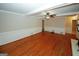 Open living room with hardwood floors, a ceiling fan, and wainscoting, creating a cozy and inviting atmosphere at 2533 Whispering Pines Dr, Grayson, GA 30017