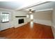 Spacious living room featuring a fireplace, hardwood floors, and a ceiling fan, perfect for relaxation and entertainment at 2533 Whispering Pines Dr, Grayson, GA 30017