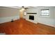 Cozy living room showcasing hardwood floors, a white brick fireplace, and natural light streaming through the window at 2533 Whispering Pines Dr, Grayson, GA 30017