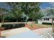 Well-maintained yard featuring a mature tree, manicured bushes, and an outbuilding, adding character to the property at 2533 Whispering Pines Dr, Grayson, GA 30017