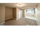 Finished basement area with neutral walls and carpet and an adjoining utility room at 2786 Altaview Se Dr, Atlanta, GA 30354