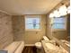 Bathroom featuring tiled shower, window, updated vanity, and neutral paint at 2786 Altaview Se Dr, Atlanta, GA 30354