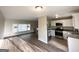 Open living space with wood floors, a view to the stairs, and a modern kitchen with granite counters at 2786 Altaview Se Dr, Atlanta, GA 30354