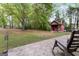 A shady backyard with a small shed can be seen from a patio in this image at 4 Bonnie Glen Ln, Hampton, GA 30228
