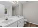Bathroom featuring double sinks and vanity with white cabinets and modern hardware at 4 Bonnie Glen Ln, Hampton, GA 30228