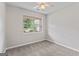 This carpeted bedroom features natural light from a window and a ceiling fan at 4 Bonnie Glen Ln, Hampton, GA 30228