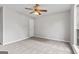 Bedroom features neutral carpet and paint, plus a lighted ceiling fan at 4 Bonnie Glen Ln, Hampton, GA 30228