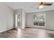 Bright bedroom with hardwood floors, fan, and backyard views through large window at 4 Bonnie Glen Ln, Hampton, GA 30228