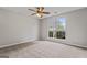 Neutral bedroom featuring a ceiling fan and large window at 4 Bonnie Glen Ln, Hampton, GA 30228