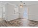 Open-concept dining area with hardwood floors, white trim, and view to kitchen at 4 Bonnie Glen Ln, Hampton, GA 30228