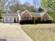 Charming one-story brick home with well-maintained lawn, driveway, and mature trees in a quiet neighborhood at 4 Bonnie Glen Ln, Hampton, GA 30228