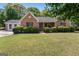 Charming one-story brick home with well-maintained lawn, mature trees, and inviting front porch at 4 Bonnie Glen Ln, Hampton, GA 30228