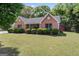 Classic brick home featuring a well-manicured lawn, tidy shrubbery, and serene, tree-lined surroundings at 4 Bonnie Glen Ln, Hampton, GA 30228