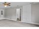 Living room features large storage cabinets and neutral colored walls and carpet at 4 Bonnie Glen Ln, Hampton, GA 30228