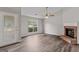 Inviting living room featuring a cozy fireplace, hardwood floors, and natural light at 4 Bonnie Glen Ln, Hampton, GA 30228
