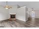Open living room with fireplace, ceiling fan, and hardwood floors at 4 Bonnie Glen Ln, Hampton, GA 30228
