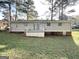View of home's backyard with patio, grass, and mature trees at 2087 John Wesley Ct, Decatur, GA 30035