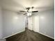 This is a view of a well-lit bedroom featuring gray walls, a ceiling fan, and a closet at 2087 John Wesley Ct, Decatur, GA 30035