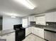 Well-equipped kitchen with granite countertops, tile floors, and stainless steel appliances, perfect for cooking at 2087 John Wesley Ct, Decatur, GA 30035