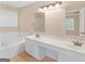 Large bathroom with soaking tub, double sinks, tile floor, and framed mirrors at 10018 Clearwater Trl, Jonesboro, GA 30238
