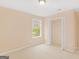 Neutral bedroom featuring a bright window and closet space at 10018 Clearwater Trl, Jonesboro, GA 30238