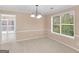A dining room boasting natural light, a chandelier, and a view to the deck at 10018 Clearwater Trl, Jonesboro, GA 30238