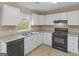 Kitchen with white cabinets and black appliances at 10018 Clearwater Trl, Jonesboro, GA 30238