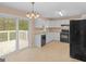 Kitchen with a deck, featuring white cabinetry and black appliances at 10018 Clearwater Trl, Jonesboro, GA 30238