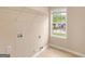 Bright laundry room with window, shelf, and hookups ready for your appliances at 10018 Clearwater Trl, Jonesboro, GA 30238