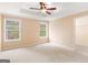 Spacious main bedroom with tray ceiling, fan, and large windows for ample light at 10018 Clearwater Trl, Jonesboro, GA 30238