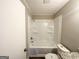 Bathroom featuring a shower-tub combo with built-in shelving and a granite-topped vanity at 837 Needle Rock Dr, Stone Mountain, GA 30083