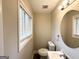 Bathroom with vanity, toilet, and a window for natural light at 837 Needle Rock Dr, Stone Mountain, GA 30083
